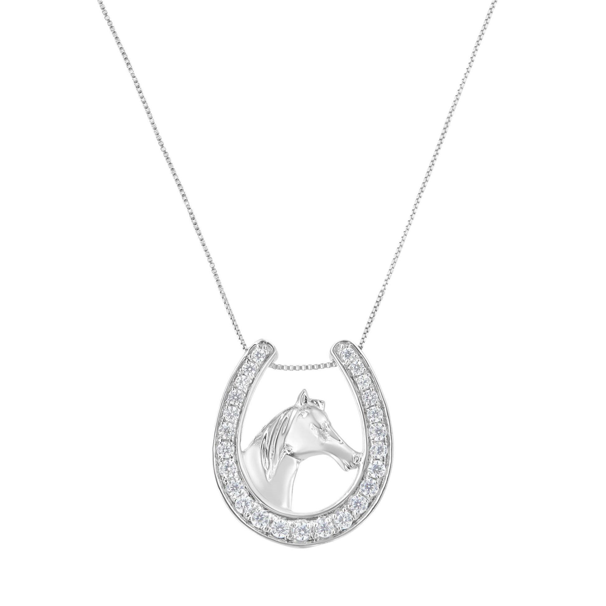 Front-facing shot of a white metal necklace featuring a horseshoe pendant lined with round white gemstones and a horse head inside the horseshoe.