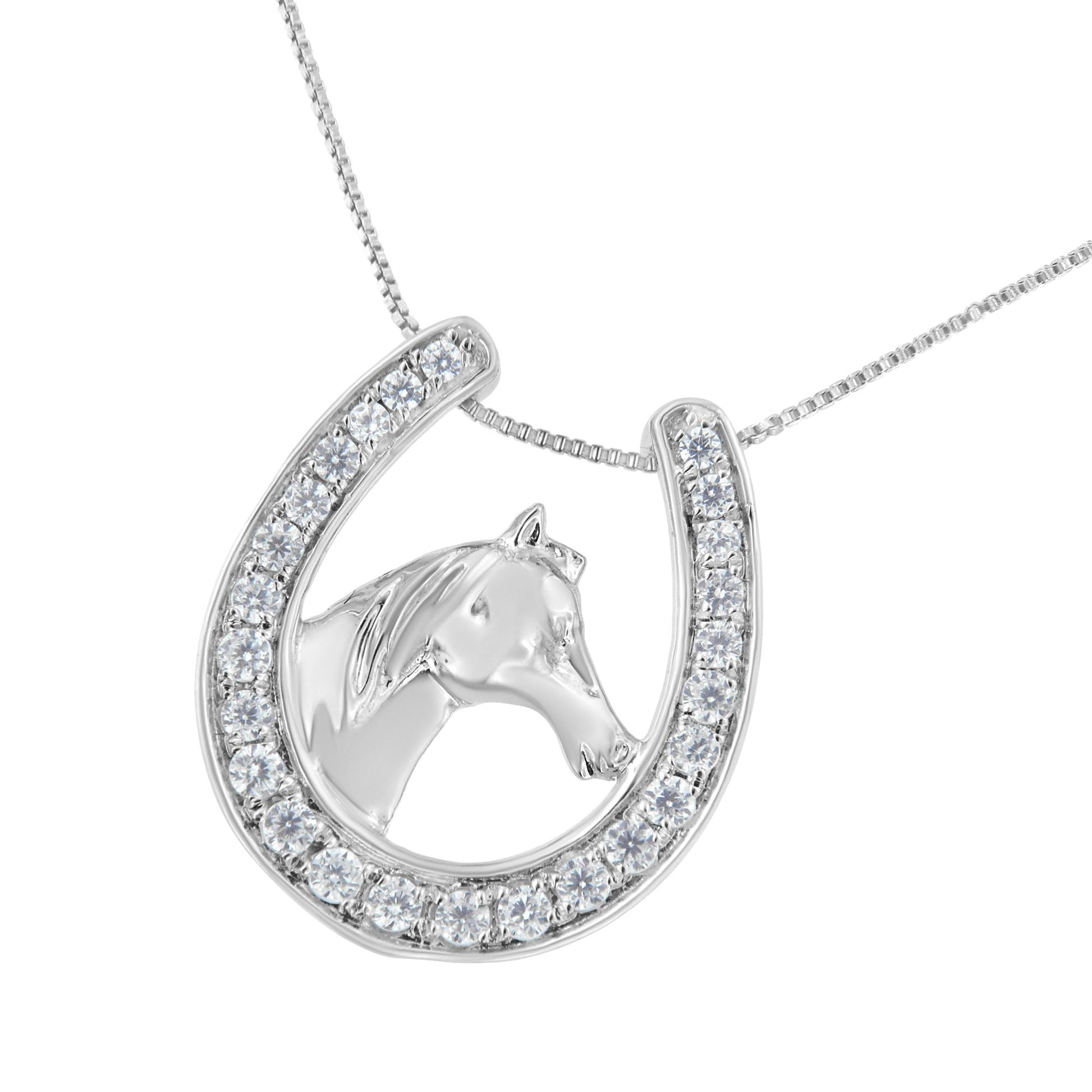 White metal necklace photographed from the front featuring a horseshoe pendant with a horse head inside, the horseshoe is set with round white gemstones in prong settings.