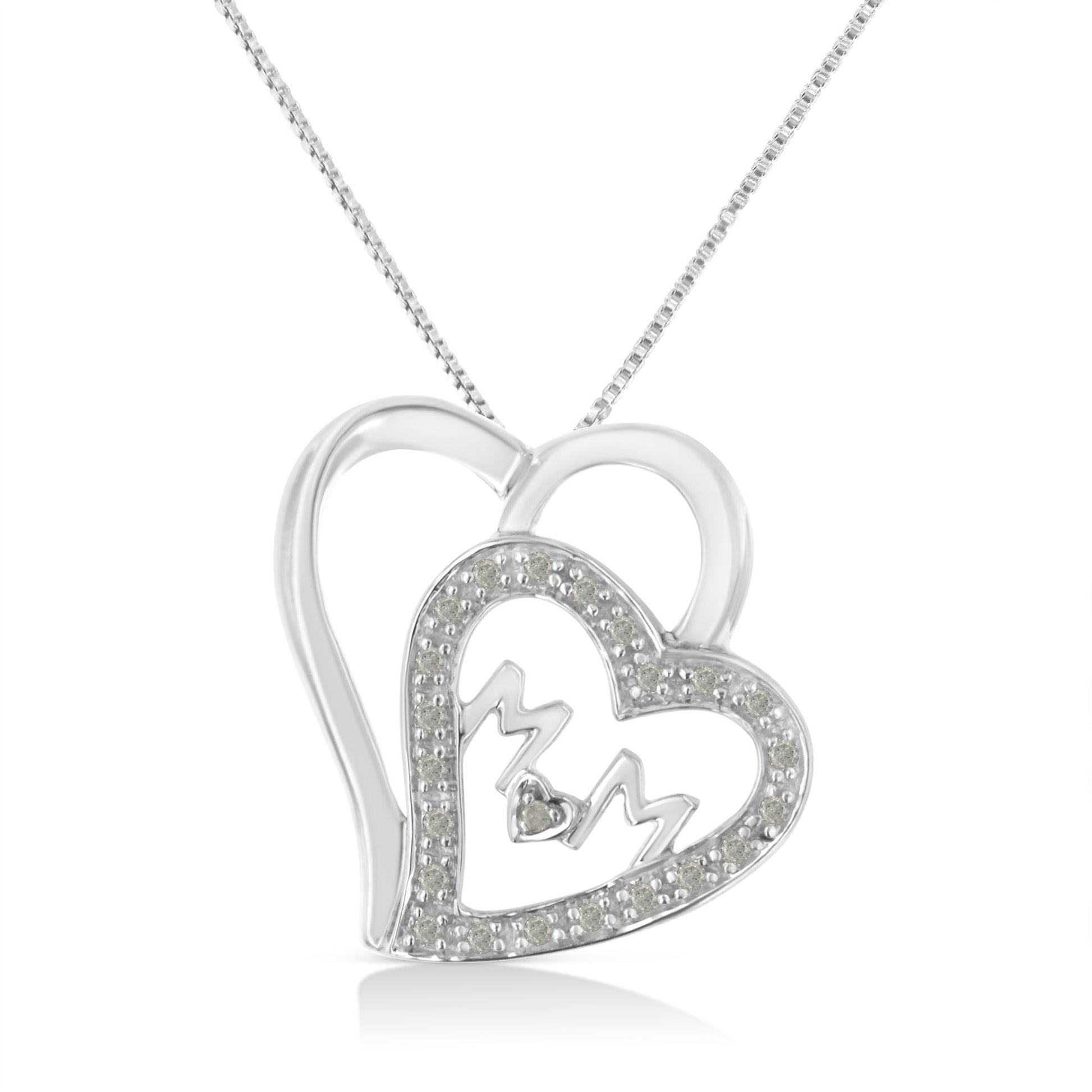 Front-facing shot of a white metal heart-shaped necklace pendant featuring an outer heart outline and an inner heart outline studded with round white gemstones in prong settings, with stylized 'MOM' lettering and a small heart shape inside the inner heart.