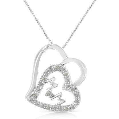 Close-up front angle of a white metal heart-shaped necklace pendant with an open design, featuring a smaller heart outlined with white gemstones and a zigzag detail inside.