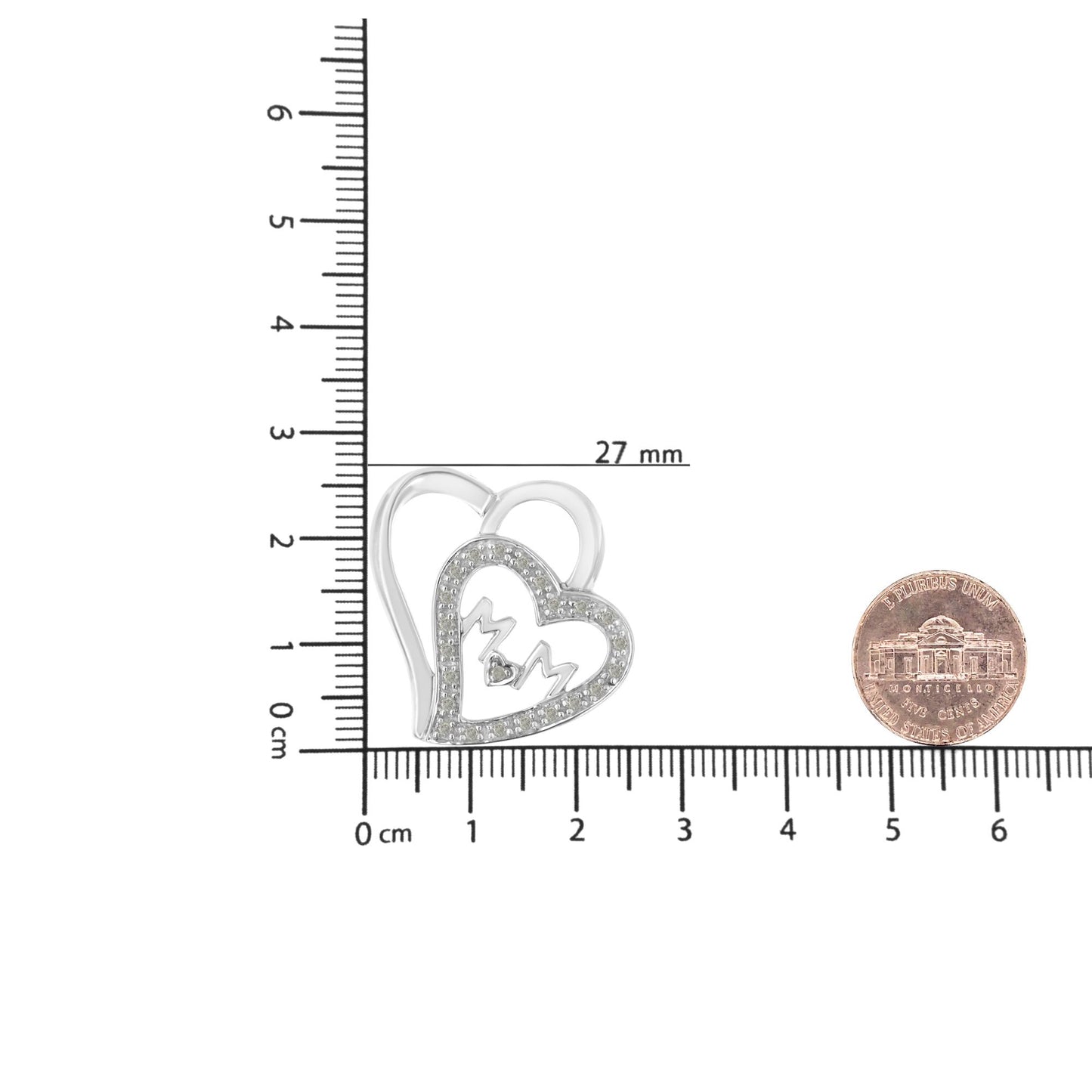 White metal heart-shaped necklace pendant with 'MOM' text and white round prong-set gemstones, shown from front on a ruler for size reference.
