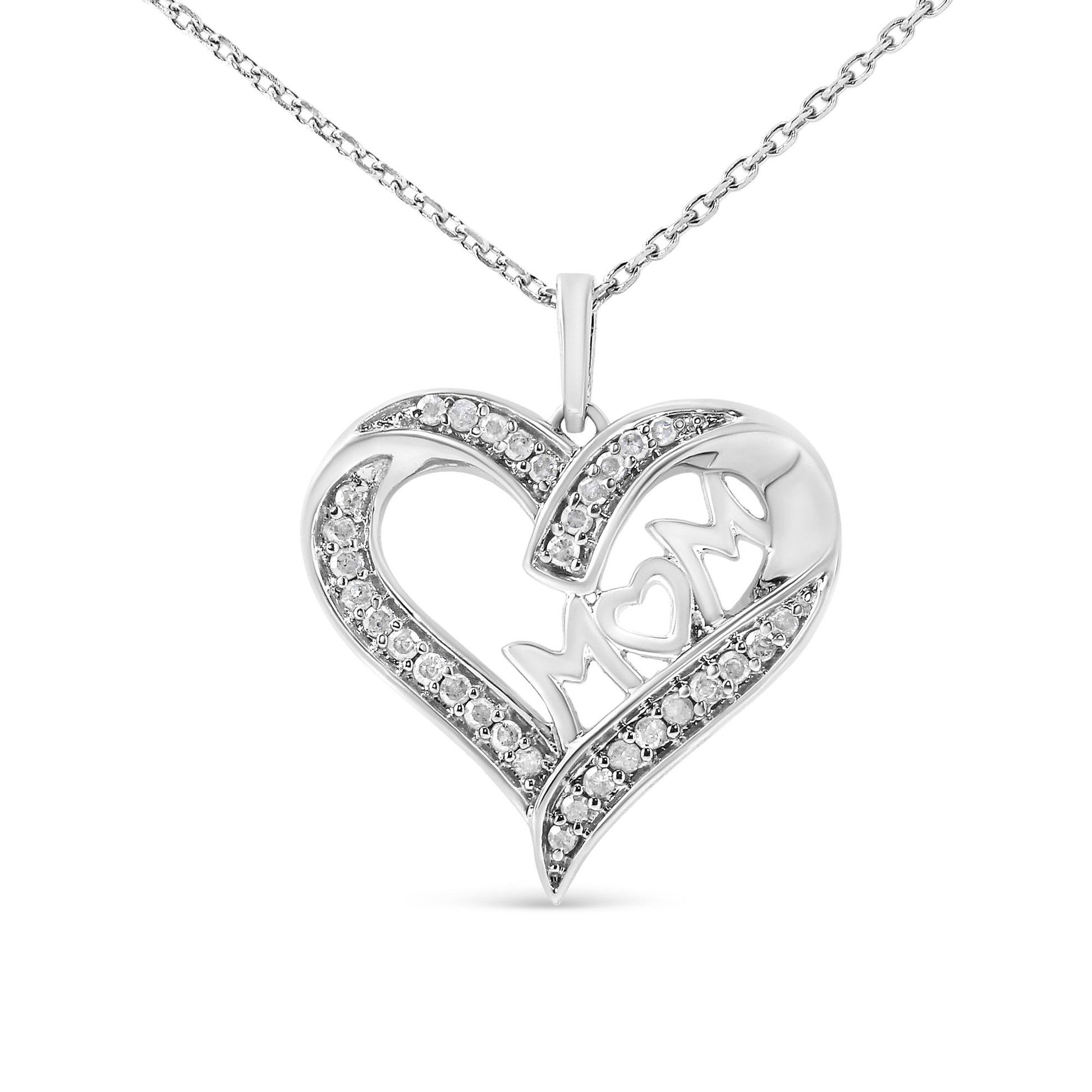 Front view of a white metal heart-shaped necklace pendant with pavé-set round white gemstones and an openwork 'MOM' inscription in the center, hanging from a matching chain.