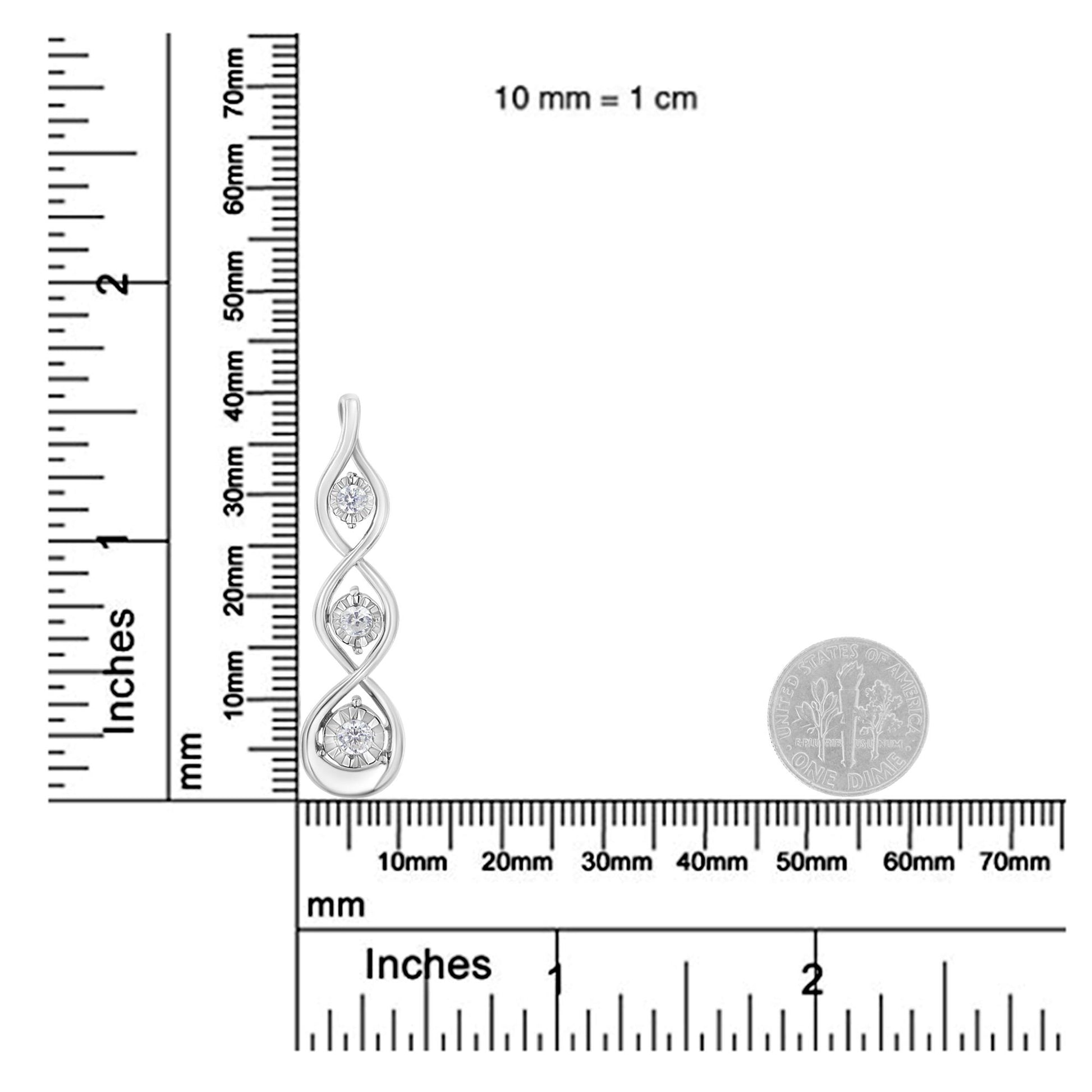 White metal necklace pendant with three round white gemstones in a vertical twisted design, shown on a ruler and scale for size reference, front angled view.