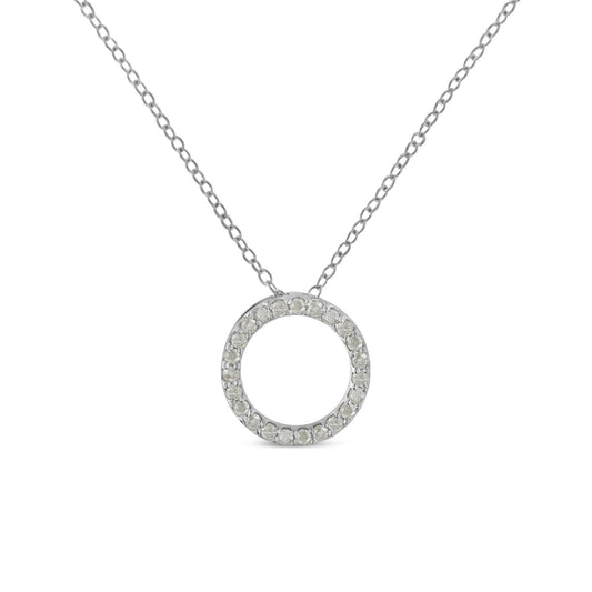 Front-facing shot of a white metal circular pendant necklace with round white gemstones in prong settings around the circle.