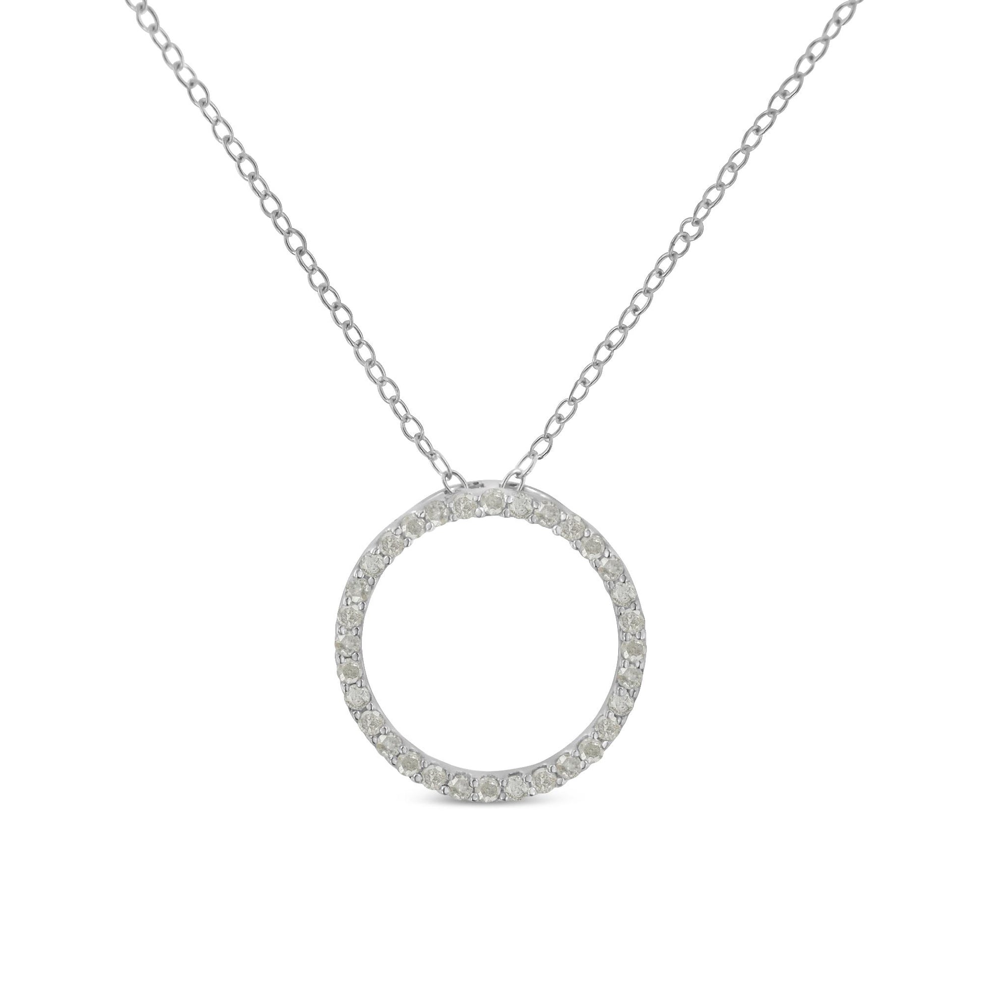 Front-facing shot of a white metal necklace with a circular pendant paved with round white gemstones.