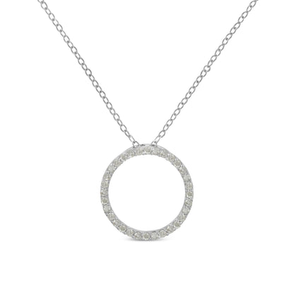 Front-facing shot of a white metal necklace with a circular pendant paved with round white gemstones.