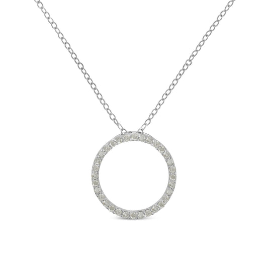 Front-facing shot of a white metal necklace with a circular pendant paved with round white gemstones.