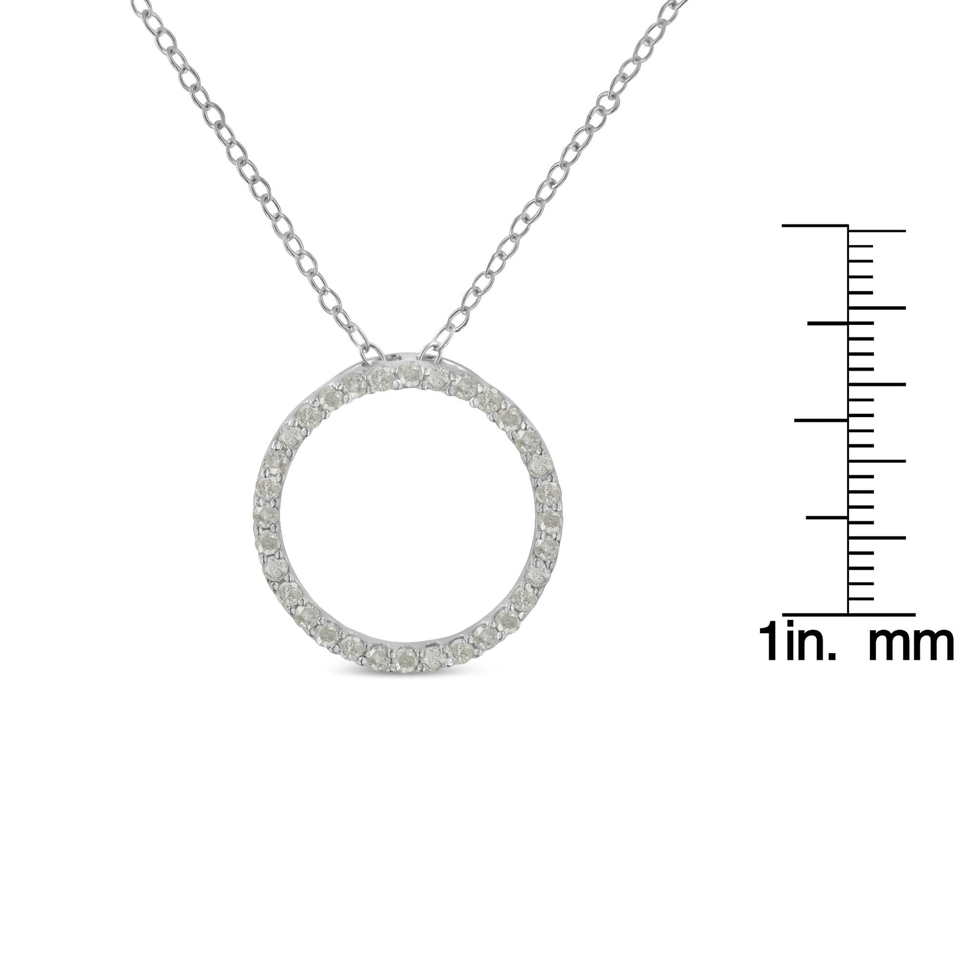 White metal necklace with a circular pendant featuring pave-set round white gemstones, shown from the front and displayed with a ruler for size reference.