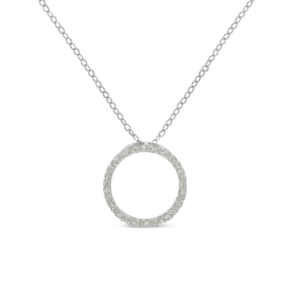 Front view of a white metal necklace with a circular pendant encrusted with round white gemstones in a pave setting.