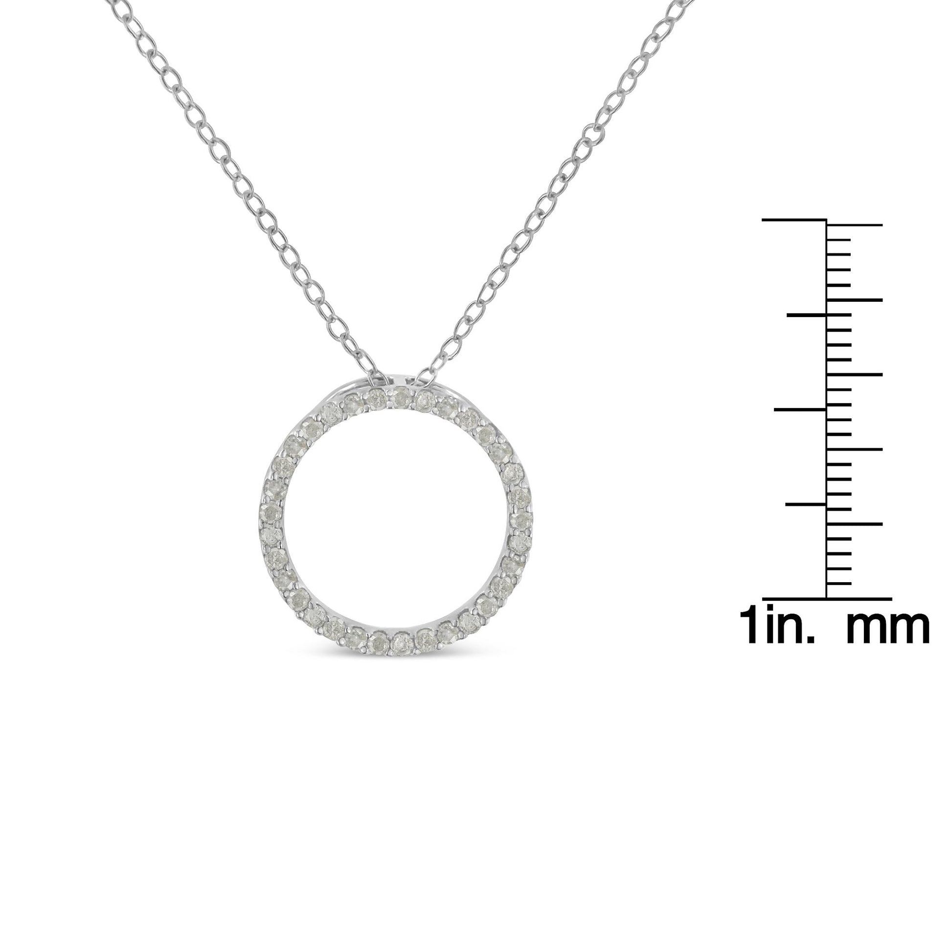 Front view of a white metal circular pendant necklace adorned with round white gemstones in a pave setting, displayed next to a ruler for size reference.