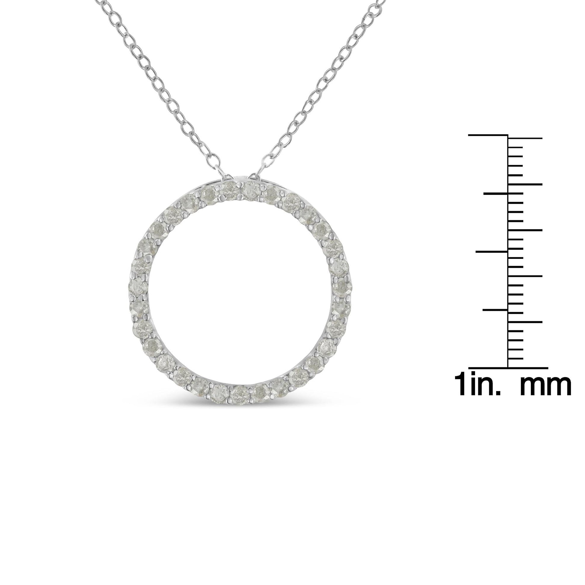 Front view of a white metal circular pendant necklace with round white gemstones in pave setting, shown with a ruler for size reference.