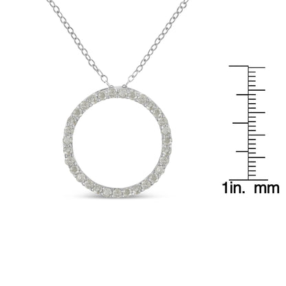 Front view of a white metal circular pendant necklace with round white gemstones in pave setting, shown with a ruler for size reference.