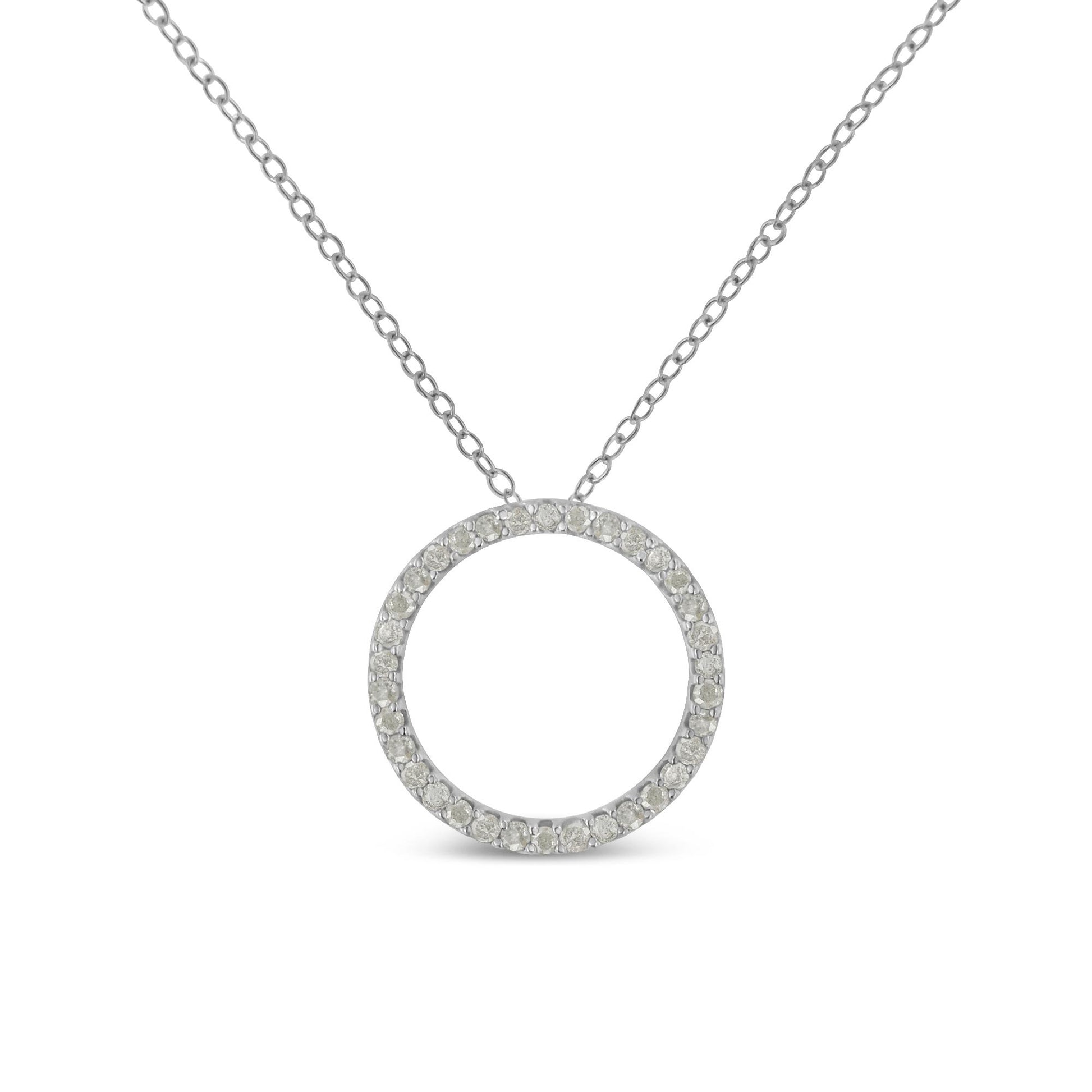 Front-facing close-up of a white metal necklace with a circular pendant paved with round white gemstones.