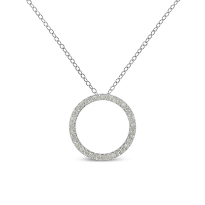 Front-facing close-up of a white metal necklace with a circular pendant paved with round white gemstones.