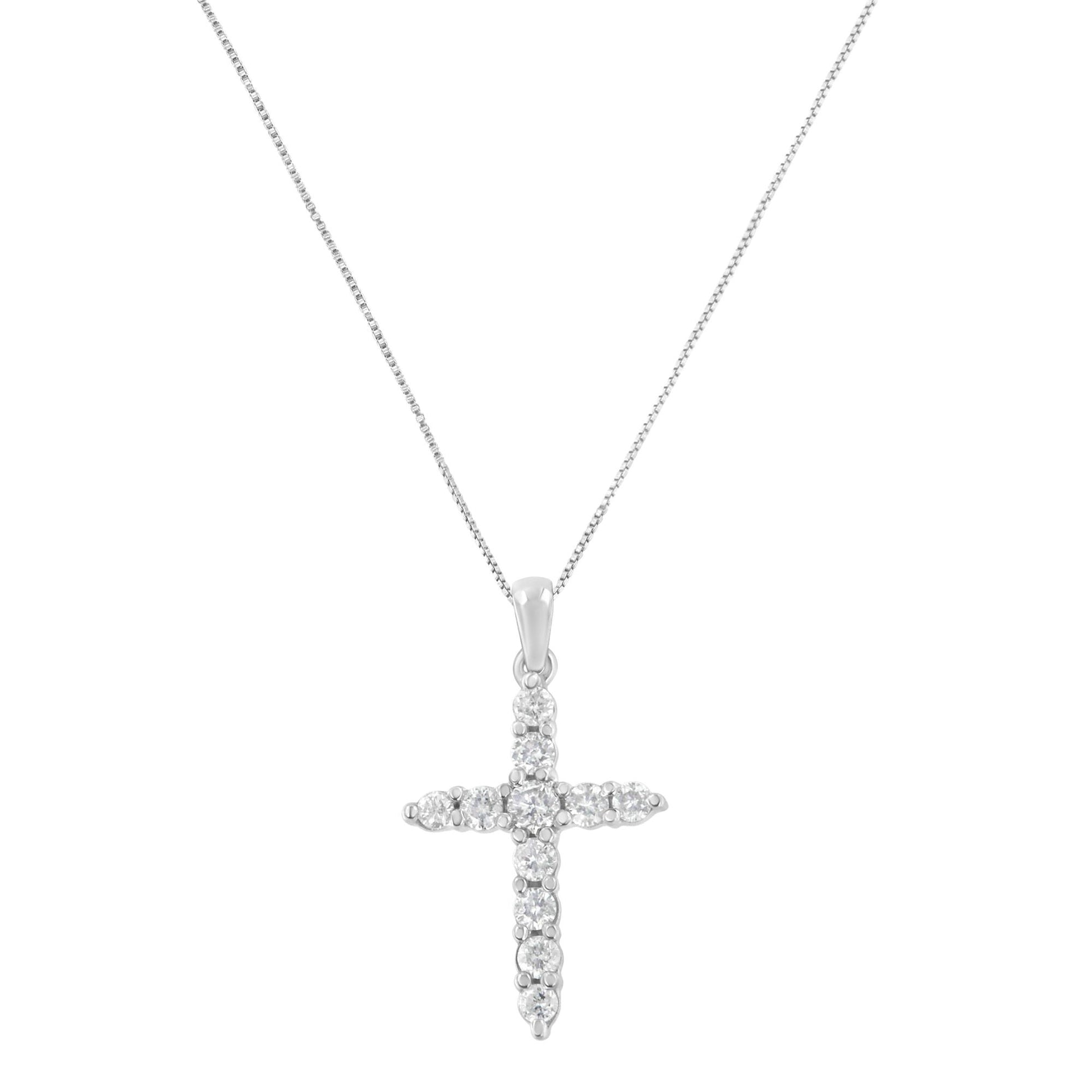 White metal necklace with a cross-shaped pendant featuring round white gemstones in prong settings, shown in a front-facing angle.