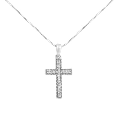 Front-facing view of a white metal cross necklace pendant with round white gemstones set in prongs, hanging from a chain.