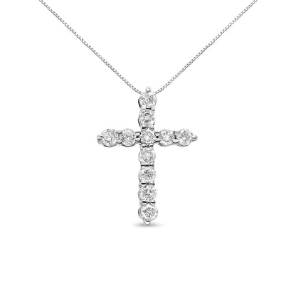 Front-facing angle of a white metal cross-shaped necklace pendant with round white gemstones in prong settings, hanging from a fine chain.