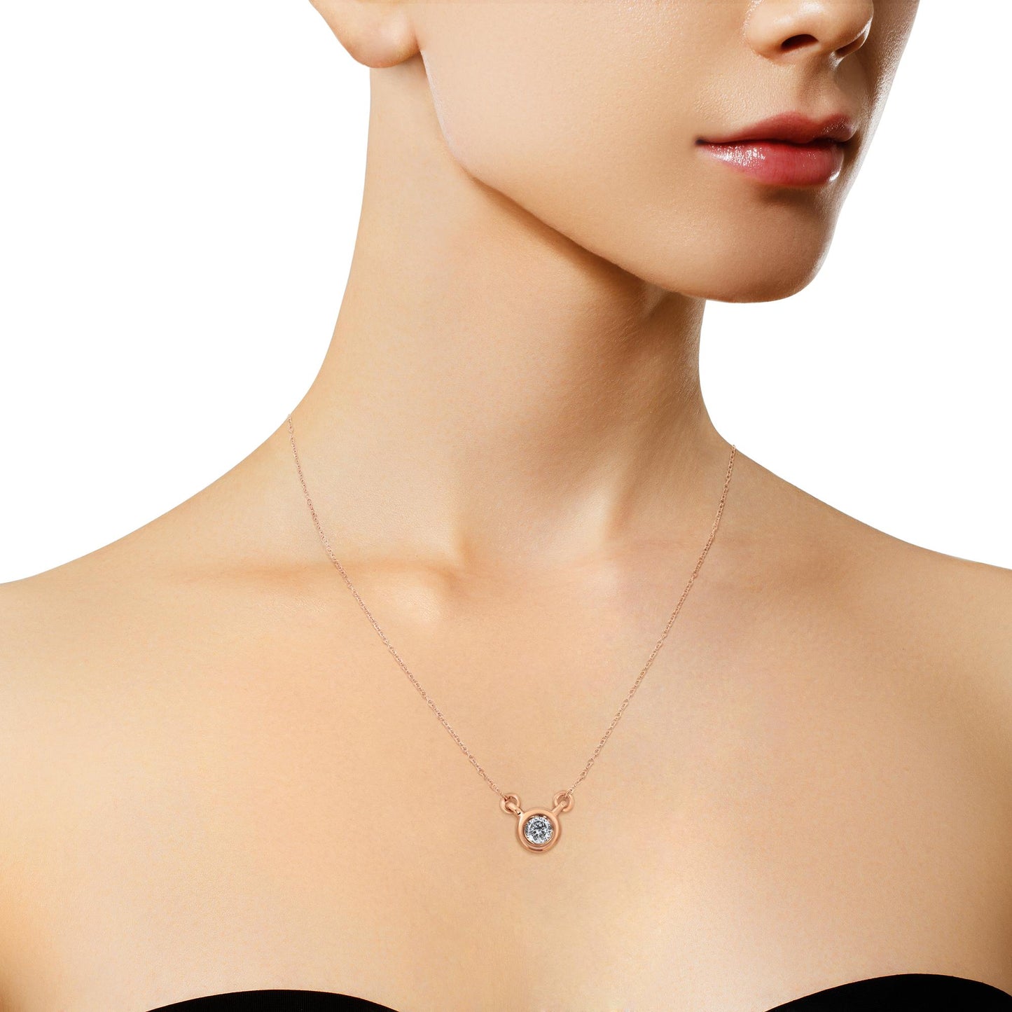 Rose metal necklace with a round white gemstone in bezel setting, worn on a model, front view.