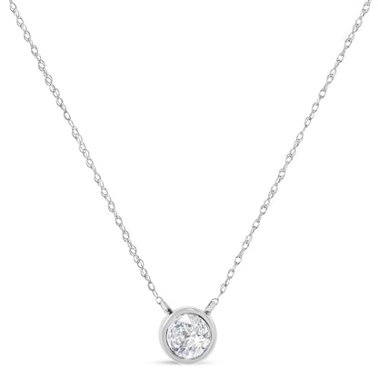 Front view of a white metal necklace with a round bezel-set white gemstone pendant.