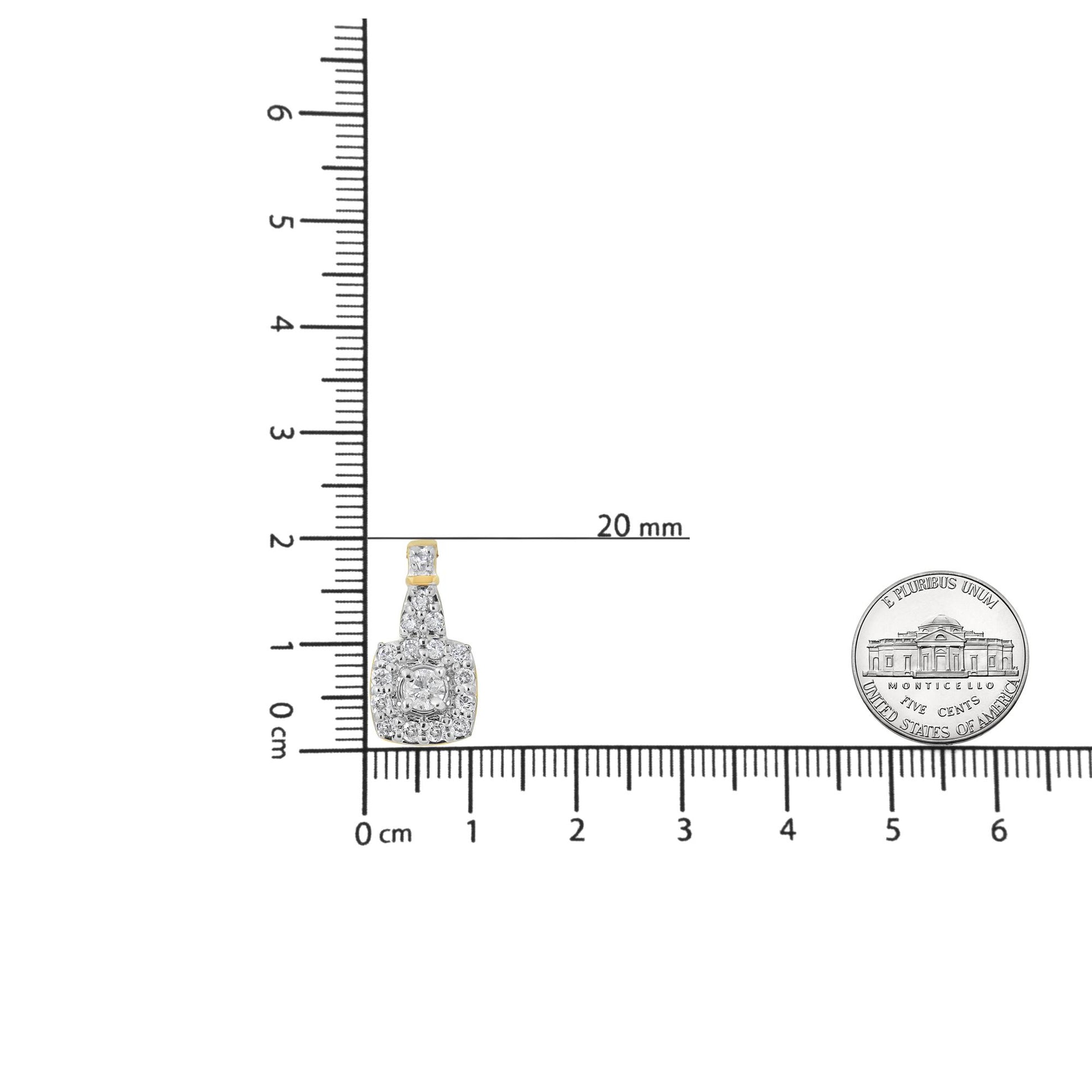 Yellow metal necklace pendant with multiple white gemstones, including one with pave setting and several with prong settings, shown on a ruler for size reference from a frontal angle.