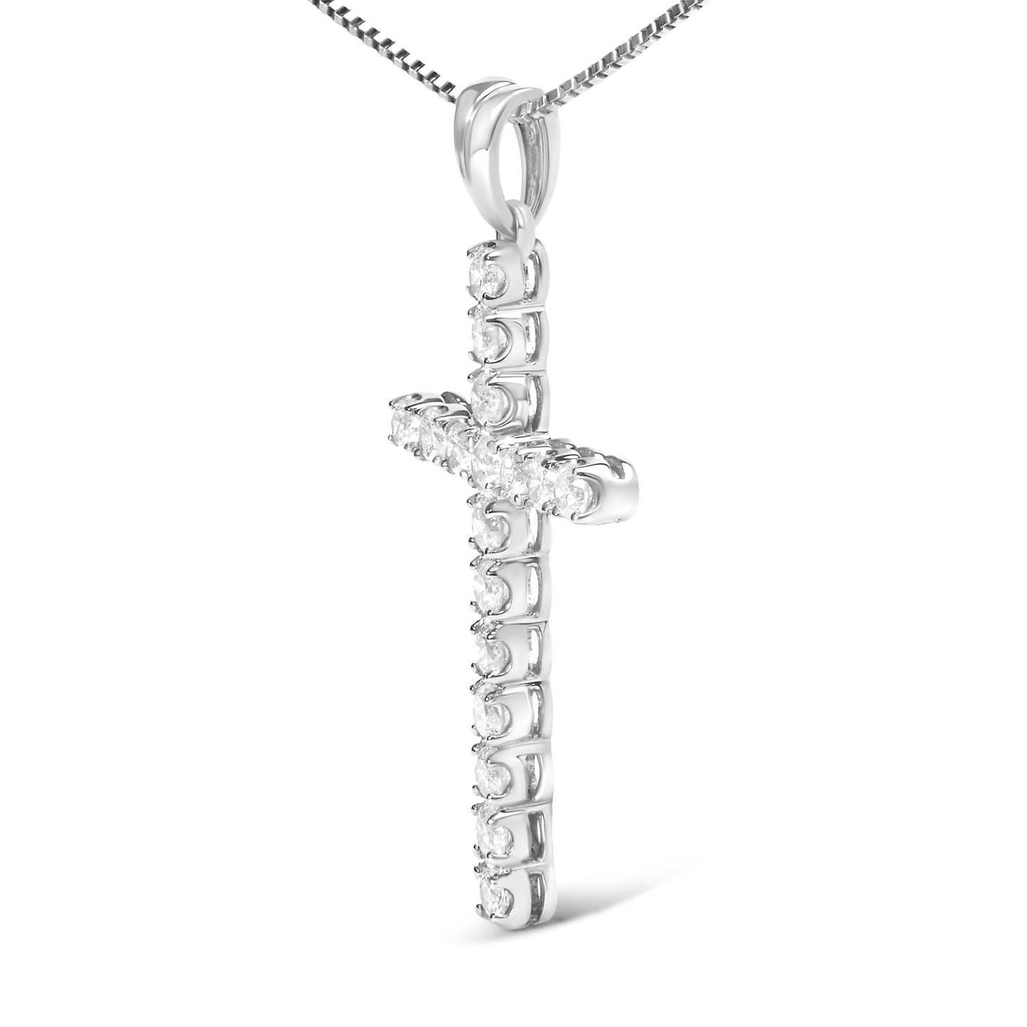 Close-up front angle of a white metal cross-shaped necklace pendant set with multiple round white gemstones in prong settings.