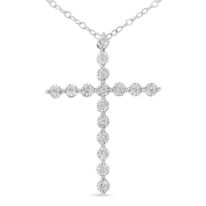 Front view of a white metal cross-shaped necklace pendant with round white gemstones in a miracle setting, suspended from a chain.