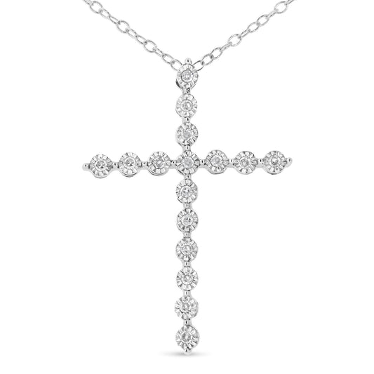 Front view of a white metal cross-shaped necklace pendant with round white gemstones in a miracle setting, suspended from a chain.