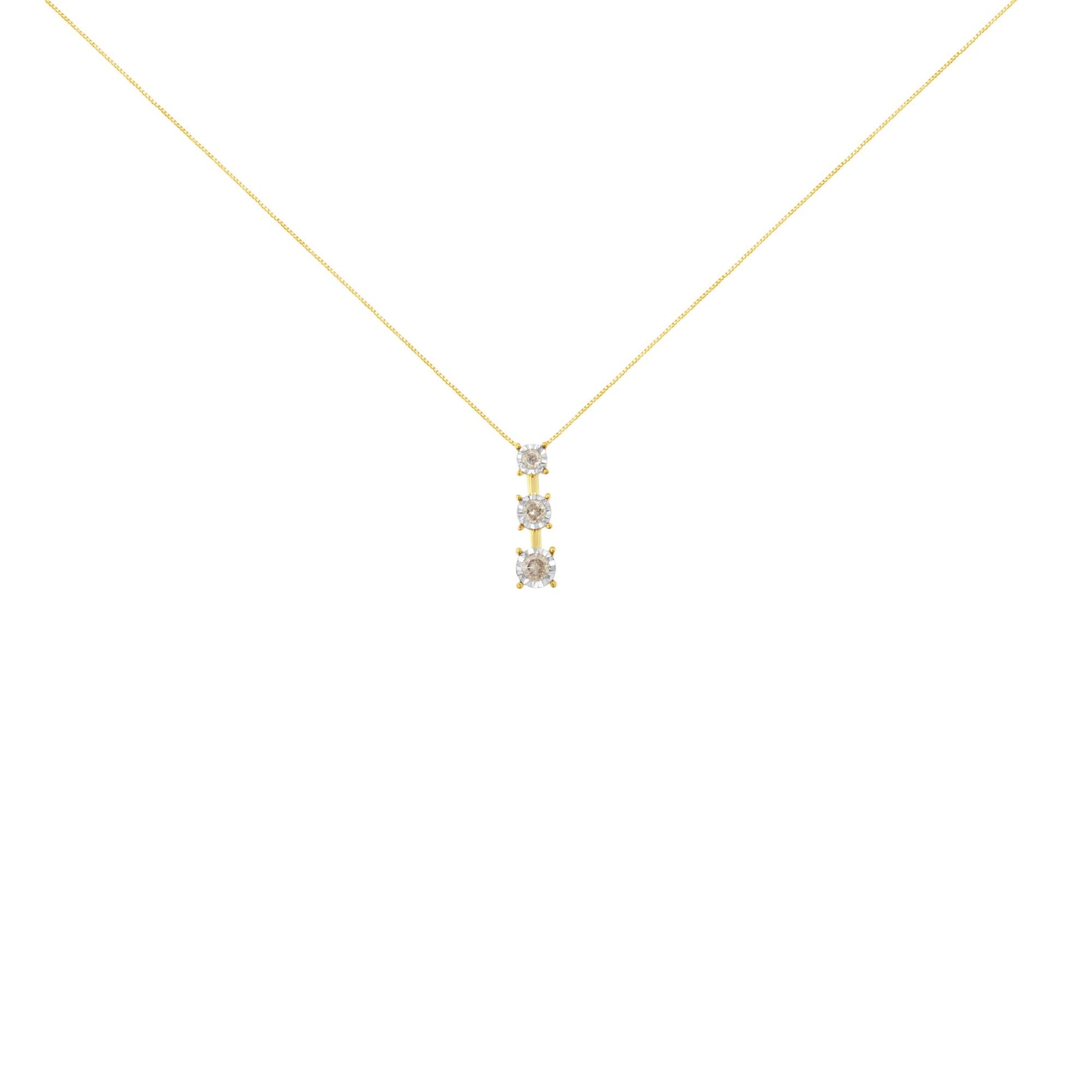 Front view of a necklace with a yellow chain and a vertical pendant featuring three round white gemstones in miracle settings with white metal prongs.