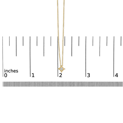 Front-facing shot of a yellow metal necklace with a princess-shaped white gemstone pendant, displayed on a ruler for size reference.