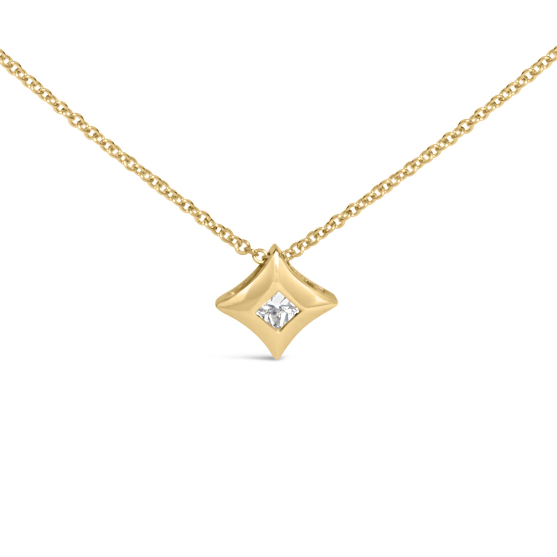Front-facing close-up of a yellow metal necklace with a diamond-shaped pendant featuring a single white gemstone set in a bezel setting.