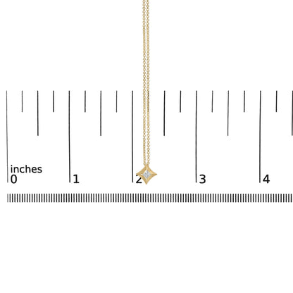 Yellow metal necklace with a small princess shape white gemstone in bezel setting pendant, shown hanging vertically on a scale, front view.