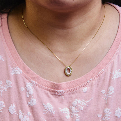 Yellow and white gemstone oval pendant necklace on a model, front close-up angle.