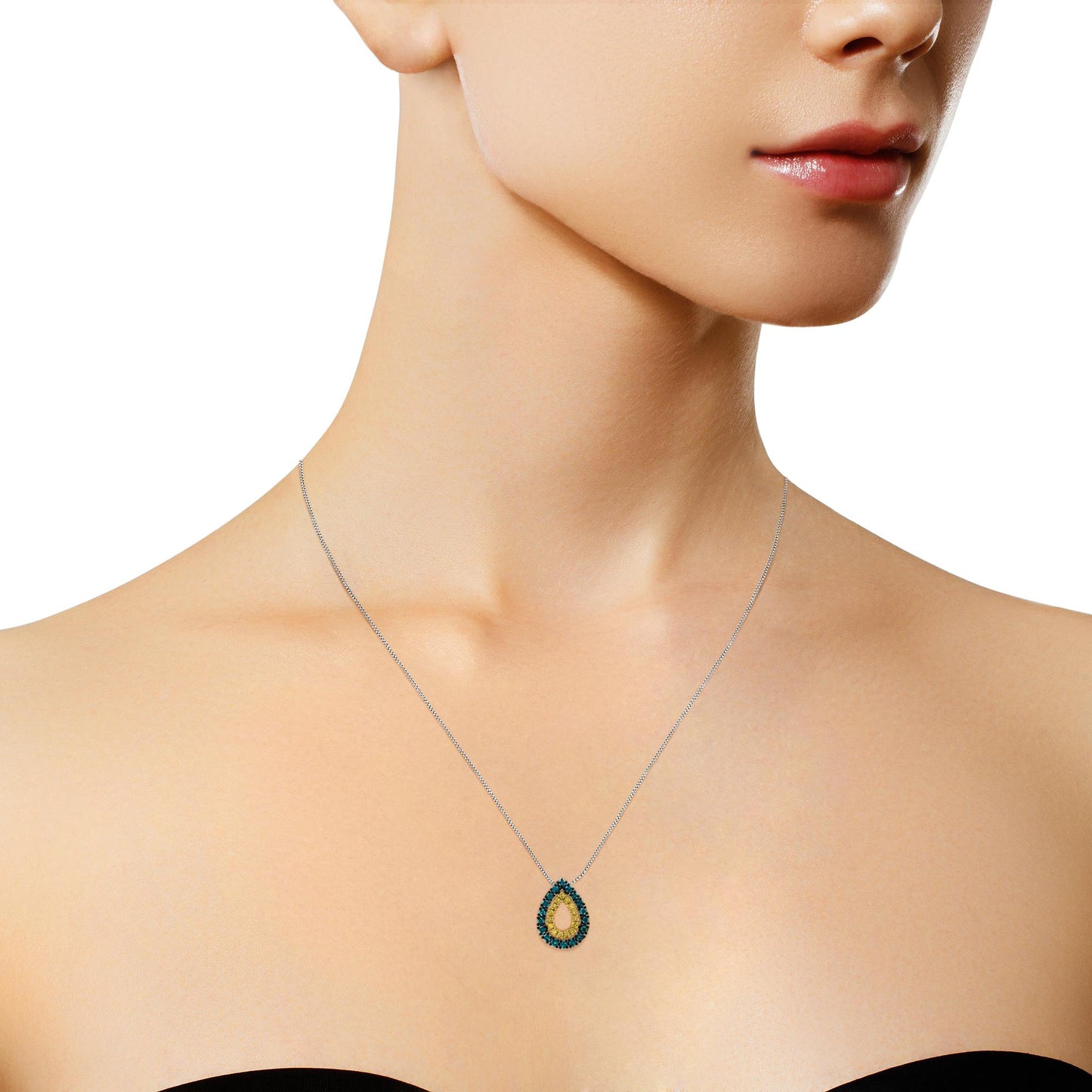 Close-up shot of a model wearing a yellow metal teardrop pendant necklace with yellow round prong-set gemstones in the center and blue round prong-set gemstones surrounding it.