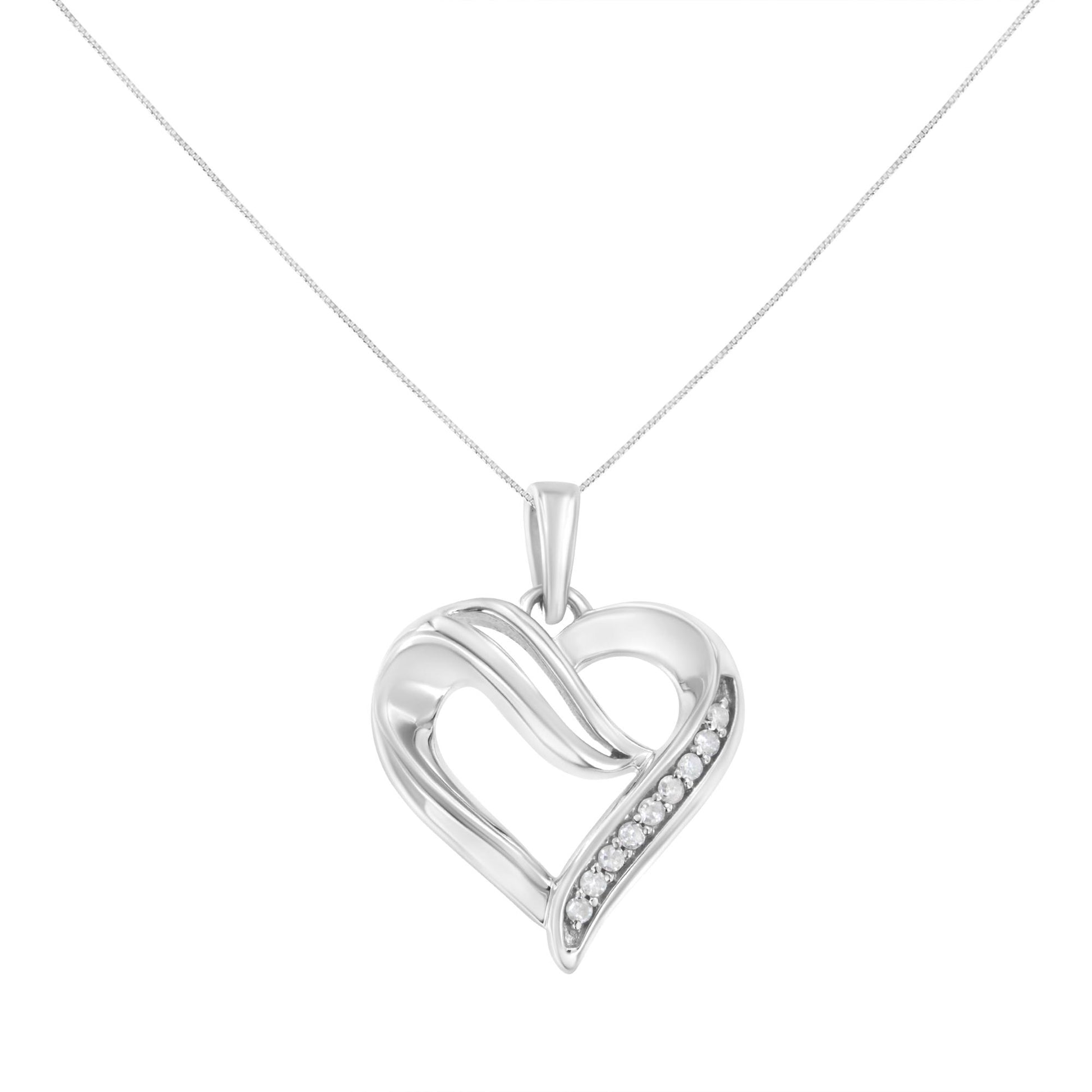 Front view of a white metal heart-shaped necklace pendant with a row of round white gemstones in prong settings along one side.