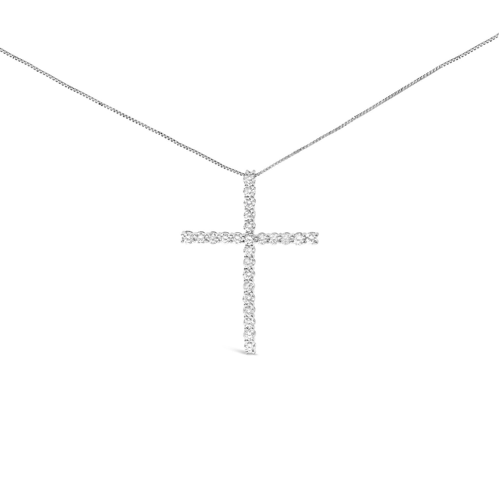 Front view of a white metal cross-shaped necklace pendant adorned with round prong-set white gemstones on a white metal chain.