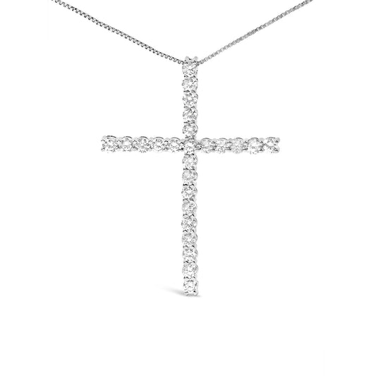 Front-facing view of a white metal cross-shaped necklace pendant with round white gemstones in prong settings on a thin white metal chain.