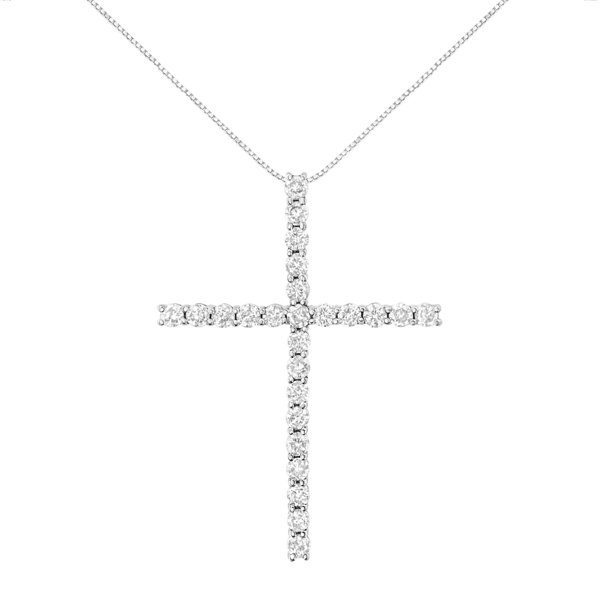 Front view of a white metal cross necklace pendant with round white gemstones in prong settings, hanging from a chain.