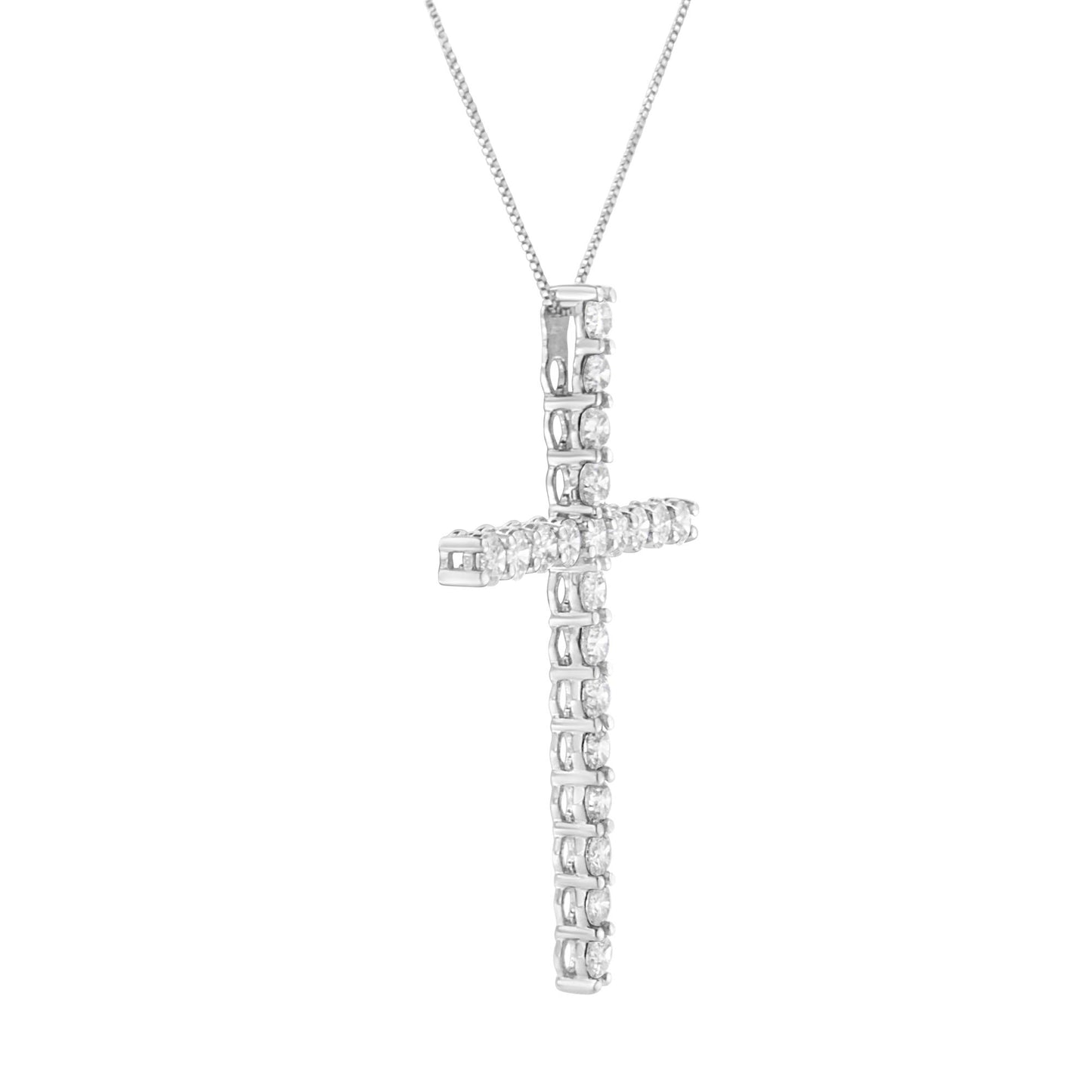 Close-up front angle of a white metal cross-shaped necklace pendant adorned with round white gemstones in prong settings.