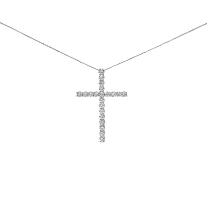 Front-facing shot of a white metal necklace with a cross-shaped pendant featuring round white gemstones in prong settings.