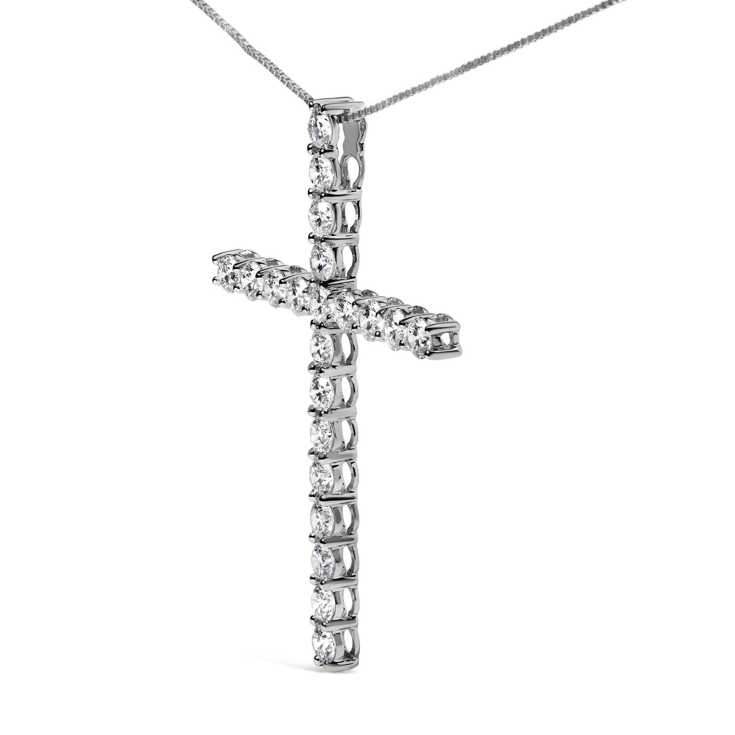 Close-up of a white metal cross-shaped necklace pendant set with round prong-set white gemstones, shown at a slight angle against a white background.