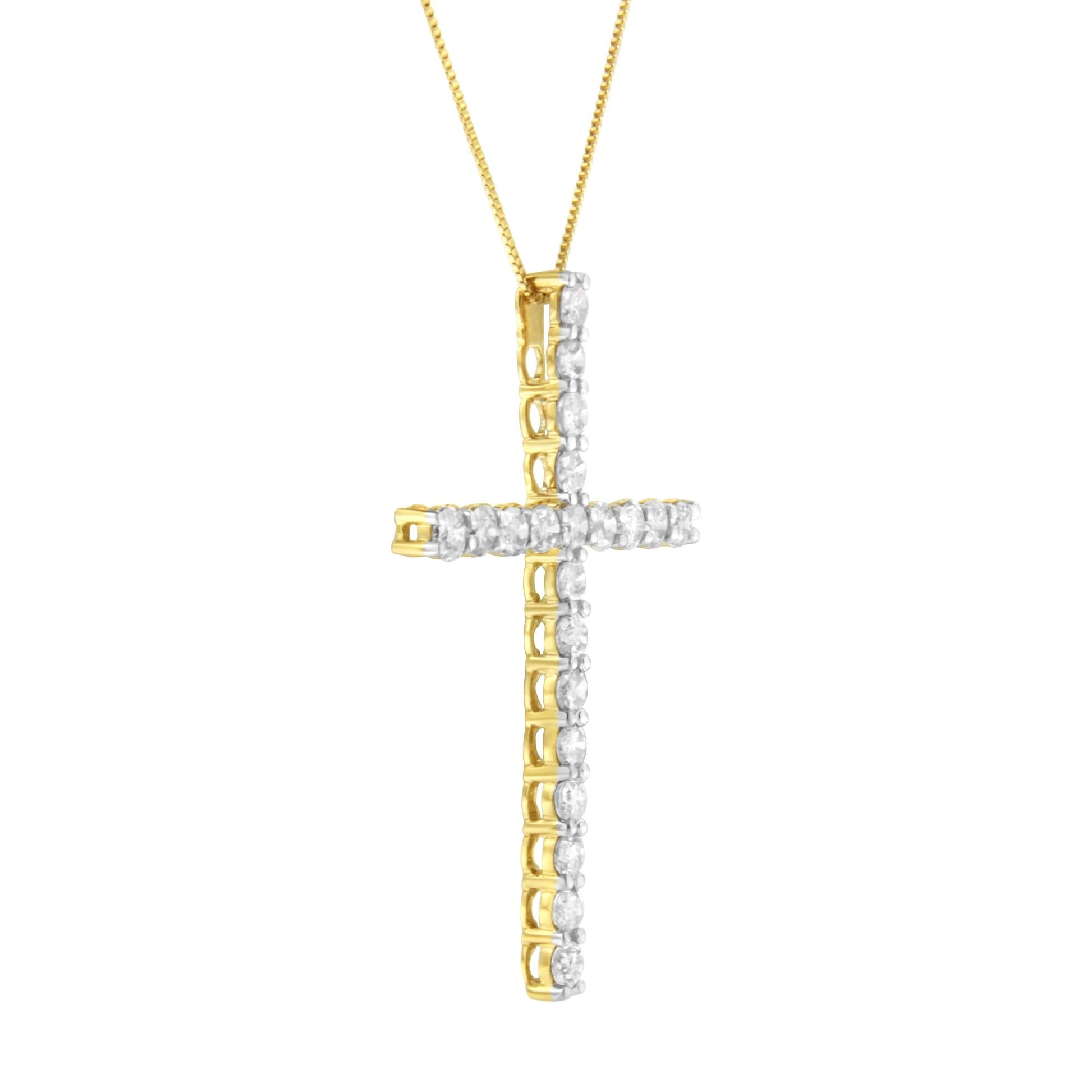 Yellow metal cross-shaped necklace pendant set with round white gemstones in prong settings, shown from a slight side angle.
