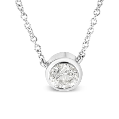 Close-up front view of a white metal necklace featuring a round white gemstone in a bezel setting.