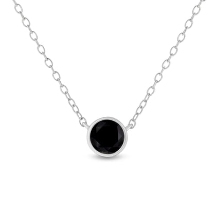 Front-facing view of a white necklace with a round black gemstone in a bezel setting on a chain.