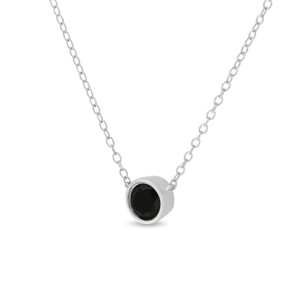 Close-up front angled view of a white metal necklace with a single round black gemstone in a bezel setting pendant.