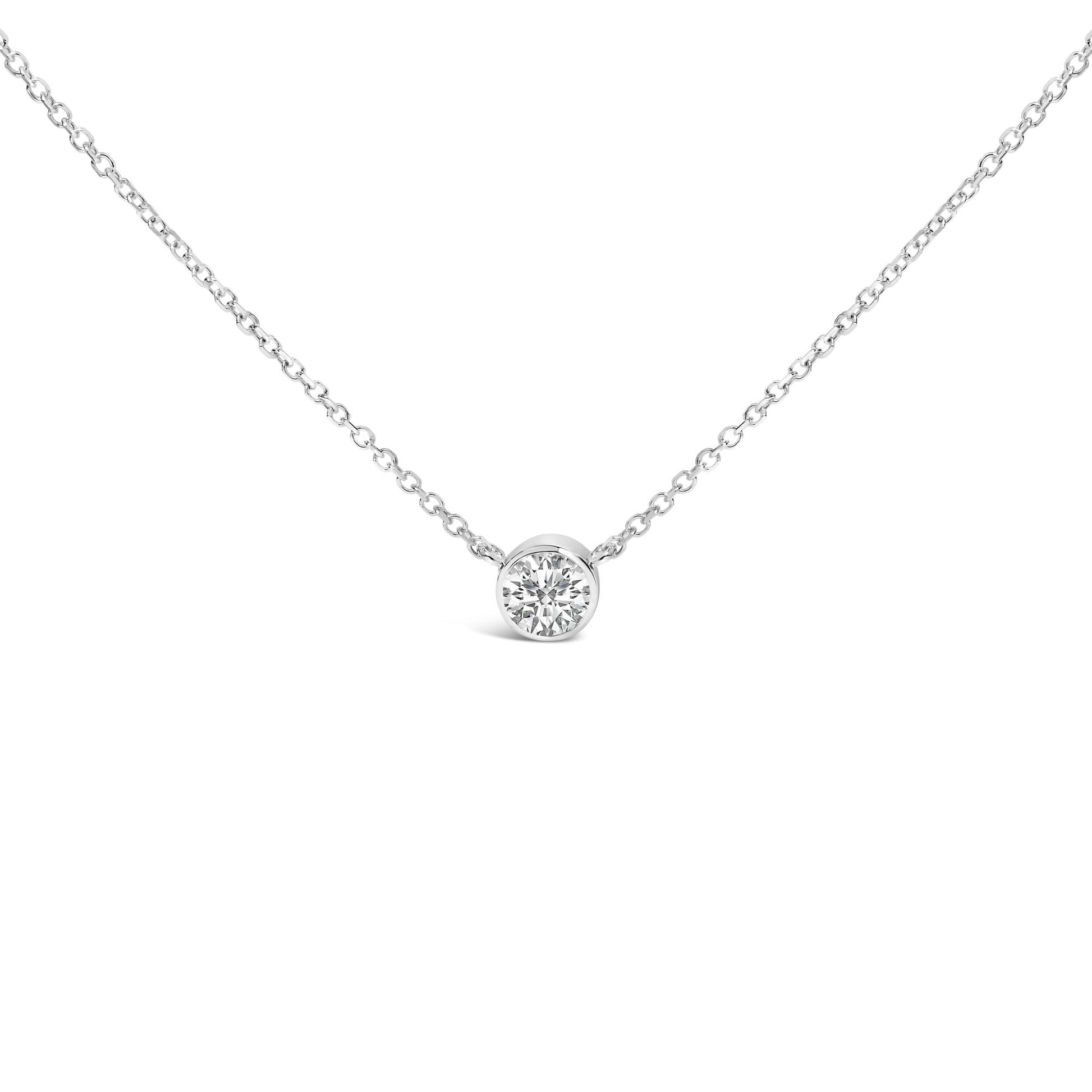 Front view of a white metal necklace with a round white gemstone in bezel setting at the center.