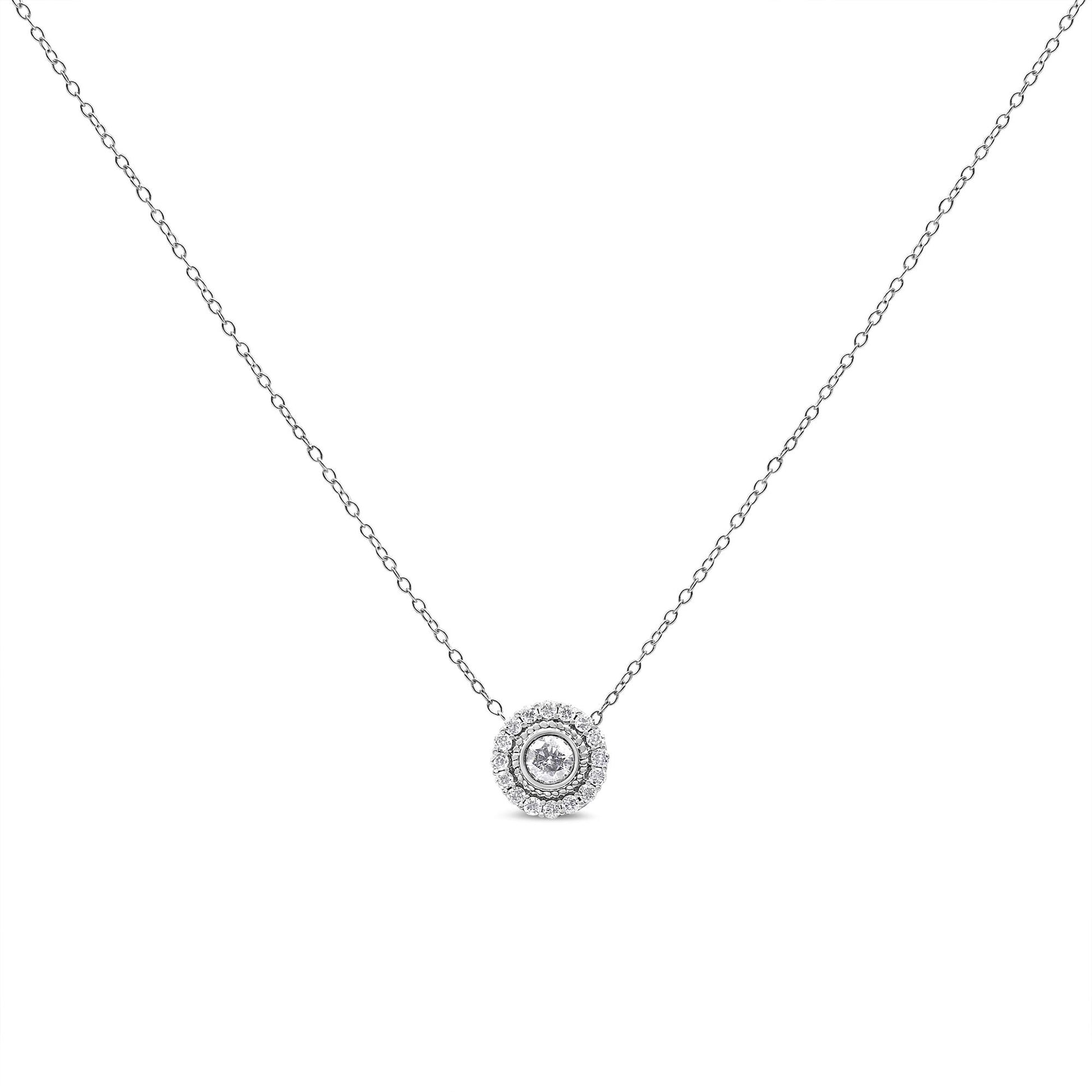 Front view of a white metal necklace with a round bezel-set white gemstone pendant surrounded by a circle of round pave-set white gemstones.