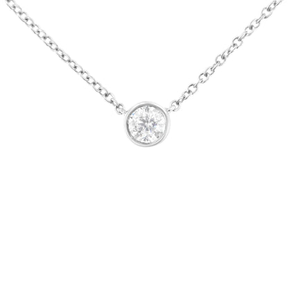 White metal necklace shown from front angle with single round white gemstone in bezel setting pendant.