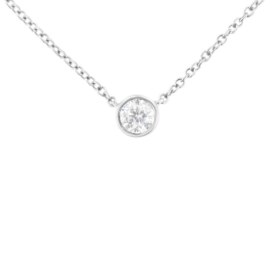 White metal necklace shown from front angle with single round white gemstone in bezel setting pendant.