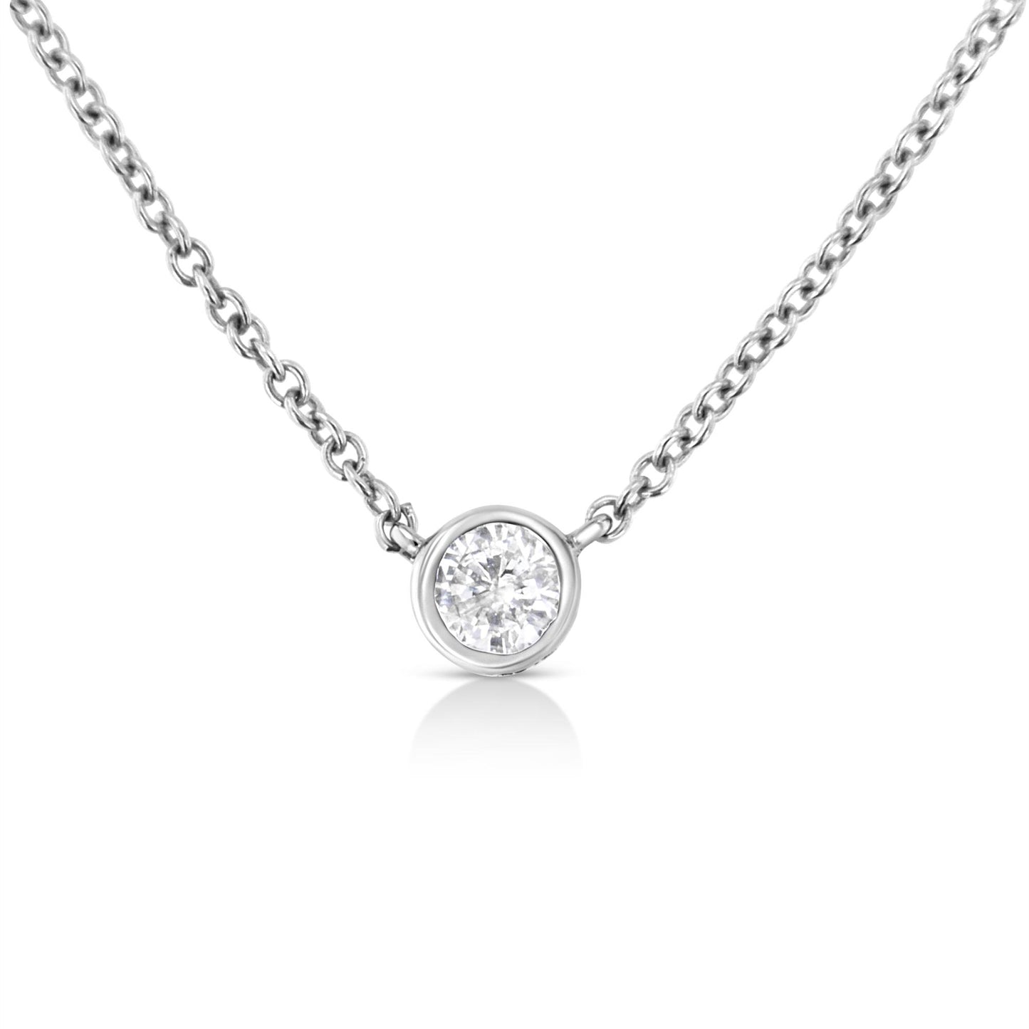 Close-up front view of a white metal necklace with a single round white gemstone in a bezel setting pendant.