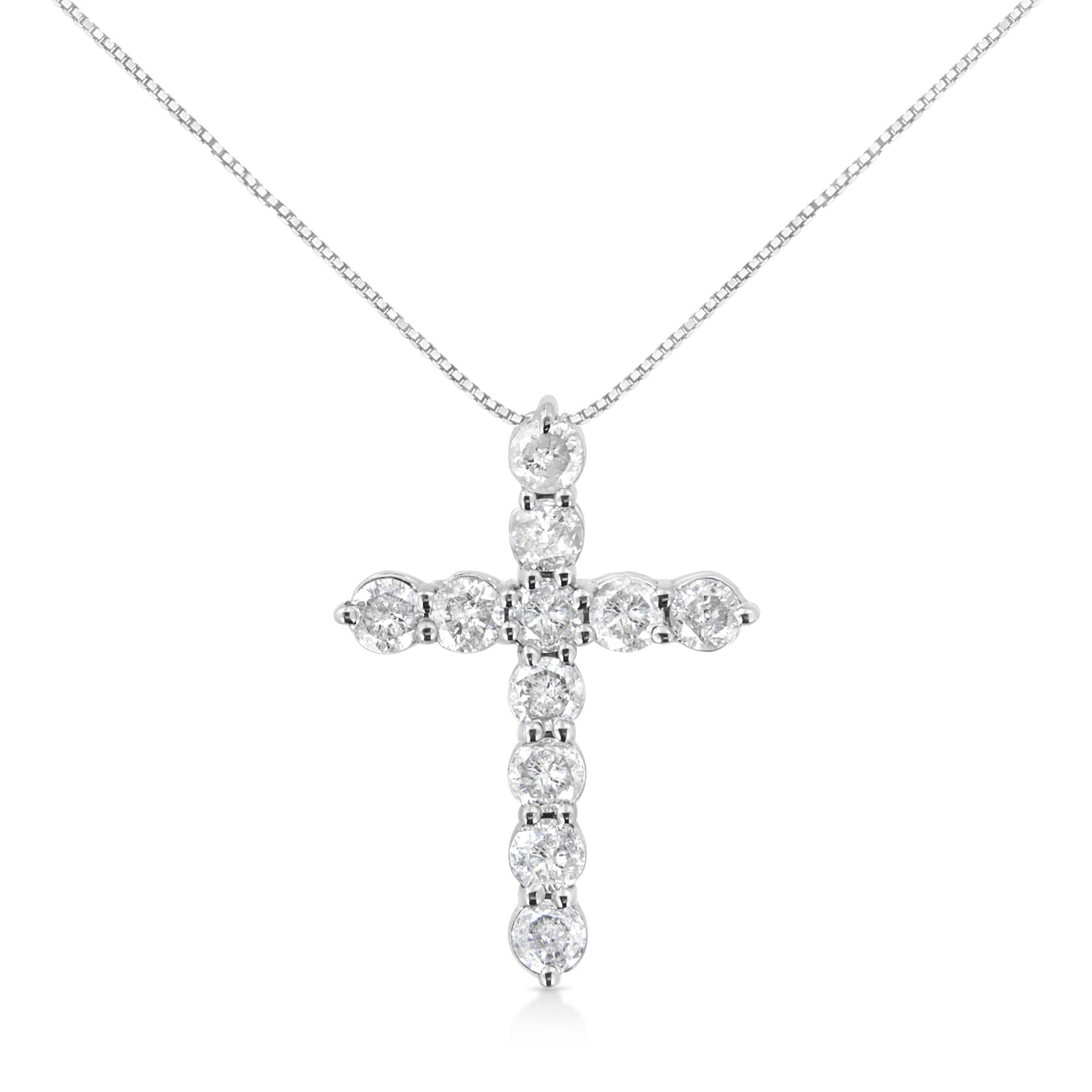 White metal necklace with a cross pendant featuring round white gemstones in prong settings, front view.